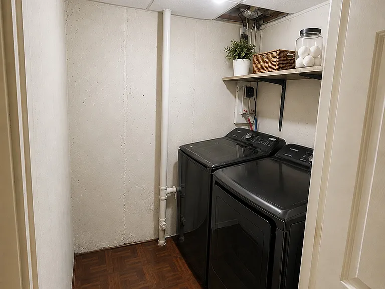 laundry room in finished lower level with newer Samsung washer & dryer