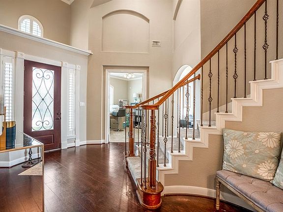 The foyer is large enough to welcome your guests into your beautiful new home with neutral paint tones throughout as well as detailed crown molding surrounding the entry door and window panel.
