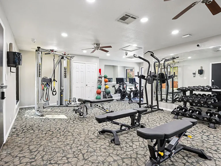 Fitness studio with cardio and strength equipment.