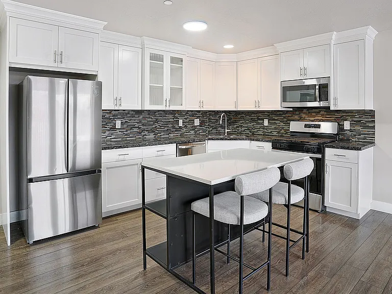 Modern kitchens feature stainless steel appliances, sleek cabinetry, and functional island space.