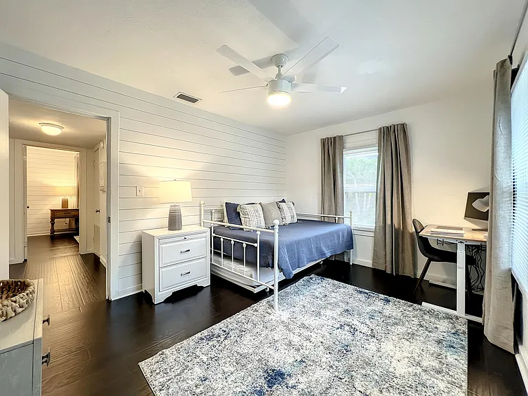 Front Bedroom/Office - blackout shades and sit/stand desk with monitor