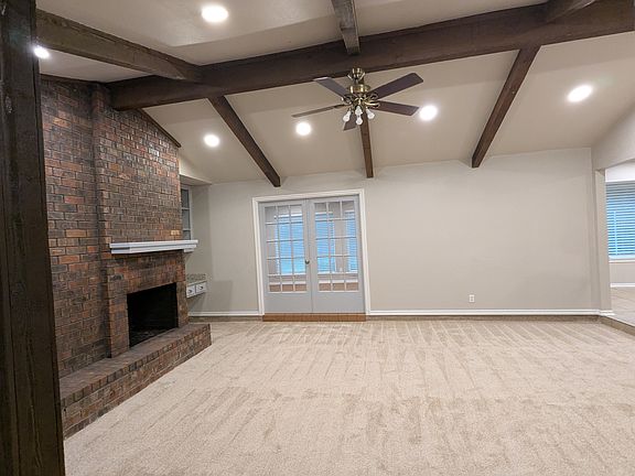 MAIN LIVING AREA: Wood burning fire place, Desk area, Ceiling Fan, The second living area is through those French doors