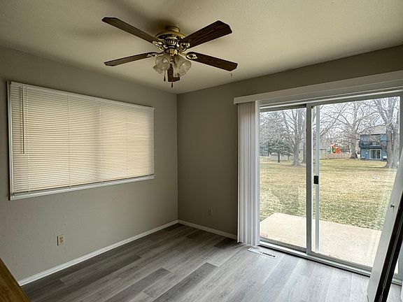Dining area looking onto the yard and open space. New laminate flooring and fresh paint