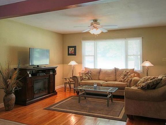 Large living room with wood floors and a big picture window to let in the light!