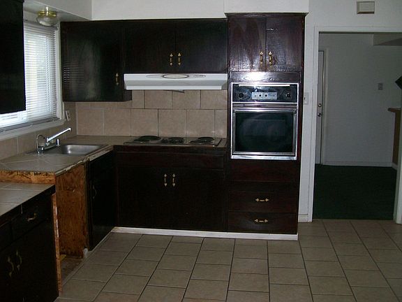 Kitchen has newer tile counters/flooring