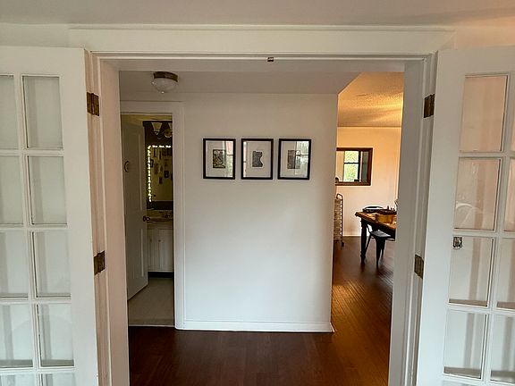 Hallway outside living room leading to dining room, powder room and eat-in kitchen