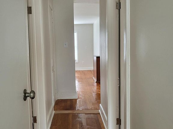 hallway leading to bedrooms bathroom and living room