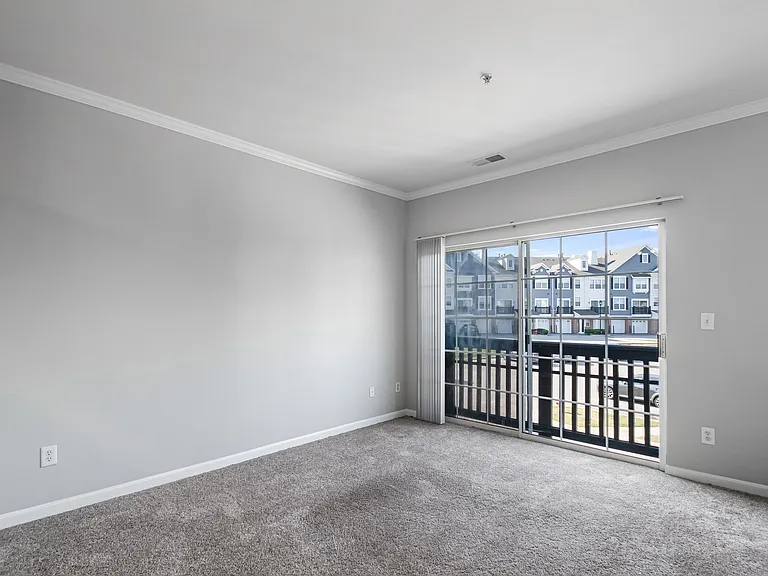 Create a comfortable retreat in this spacious, naturally lit bedroom.