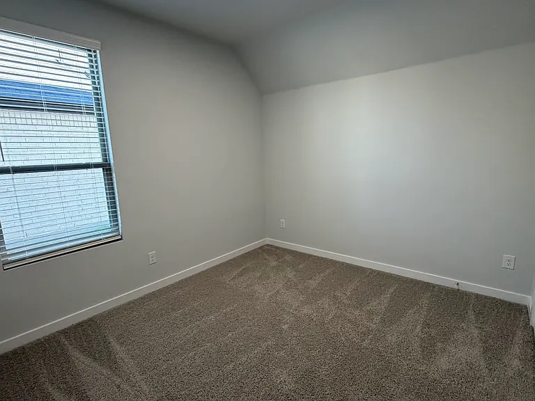 Generously sized secondary bedroom on the first floor offers a perfect guest retreat or a private, quiet space for a second home office