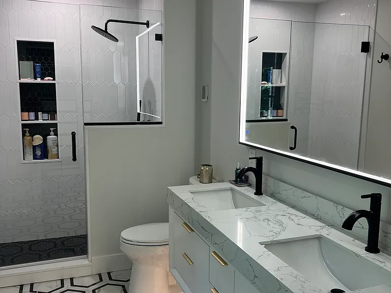 Primary bath with floating vanity, double sinks and tons of bespoke lighting.