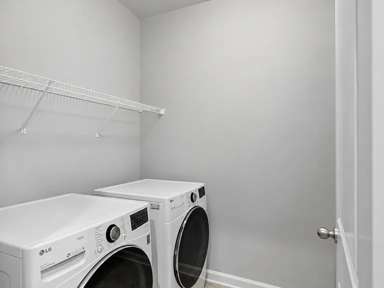 Laundry room across from primary suite