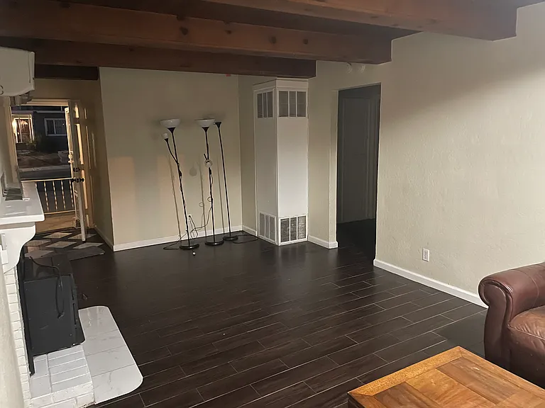 in the living room, walking from kitchen to hallway
