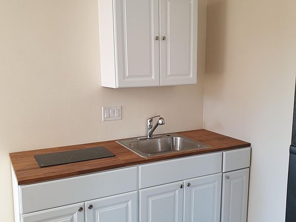 Kitchen with cooktop and sink, refrigerator is provided