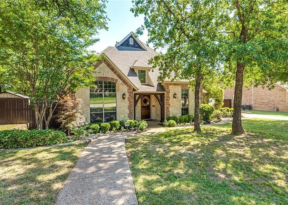 Stone & brick elevation with cedar accents is nestled on nearly half acre treed lot on cul-de-sac street in Hidden Lakes, Keller's highly popular golf course community!