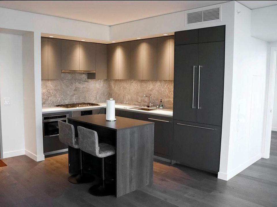 luxury open kitchen, all bosch appliances: double french door refrigerator and bosch built in microwave driver + dishwasher, and gas stove + vent that goes out of unit. Beautiful undercabinet lighting matched with island.