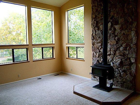 high ceiling family room with wood stove