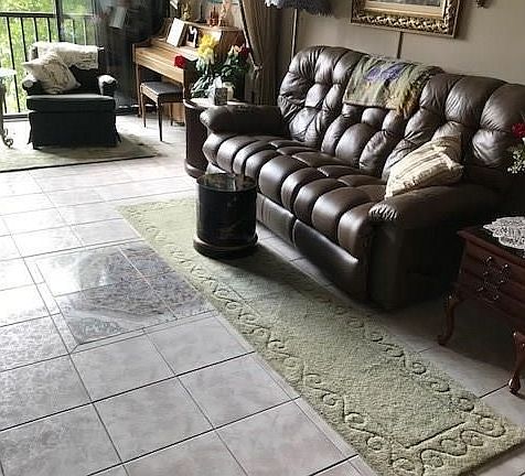 Great room with lanai enclosed with glass for additional living area.