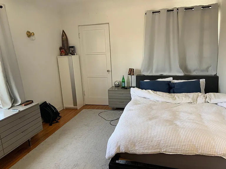 Master bedroom on the 2nd floor with windows facing north and west. The closet door leads to a storage area or study nook with windows on the west, north, and east walls.