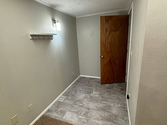 Shows door/entry to apartment and entry area, including coat rack.