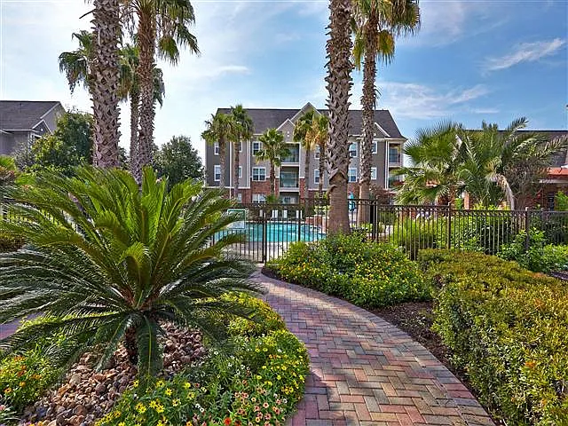 Lush landscape walkway to pool