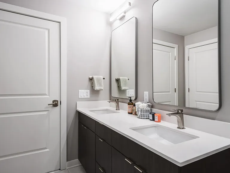 Designer bathrooms with double vanities and quartz countertops