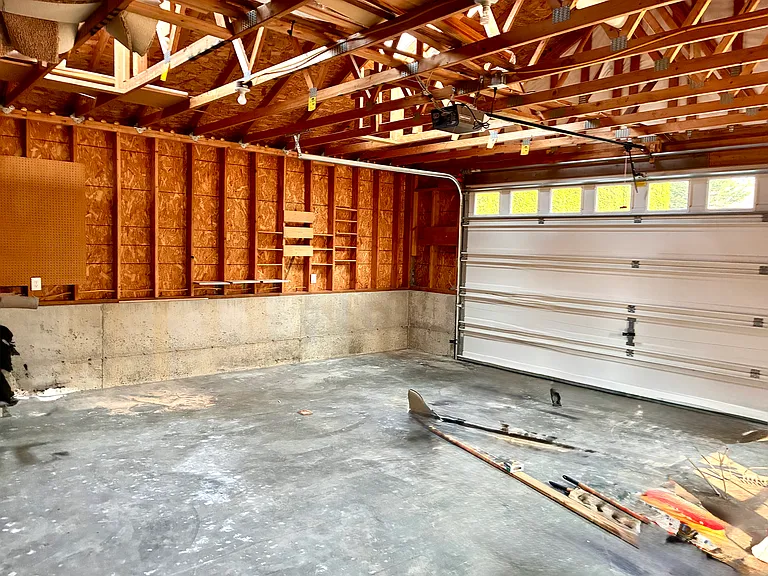 570 sqft double car garage with ample workbench space. Additional storage galore.