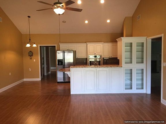 Open floor plan with view from great room into eat in kitchen