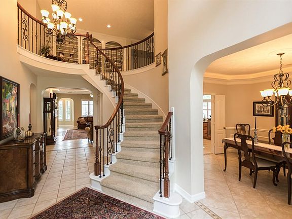 Stunning wrought iron spiral stair case greets you as you enter the home.