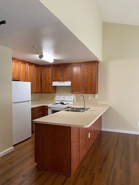 Updated cabinets, flooring, countertops and refrigerator.