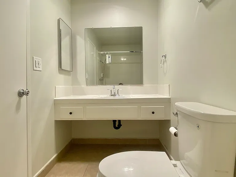 Additional view of ensuite bathroom vanity, with storage and medicine cabinet