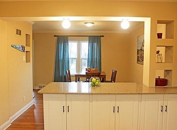 Dining Room open to Kitchen for a nice Open Floor Plan. Notice the Kitchen cutouts on the right! Cute!