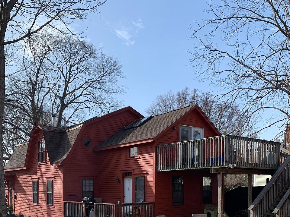 View of upstairs deck and french doors from driveway