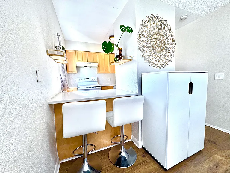 Extra pantry storage and breakfast counter with stools