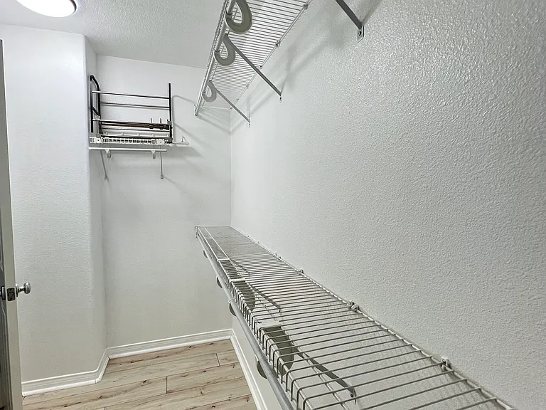 Different view of a great size of the primary room's walk in closet.