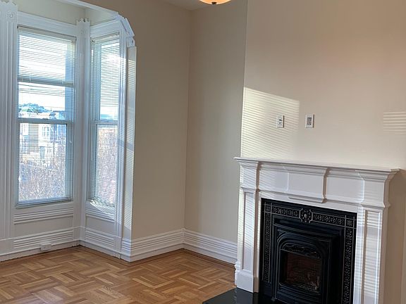 Living room with gas fireplace and bay window