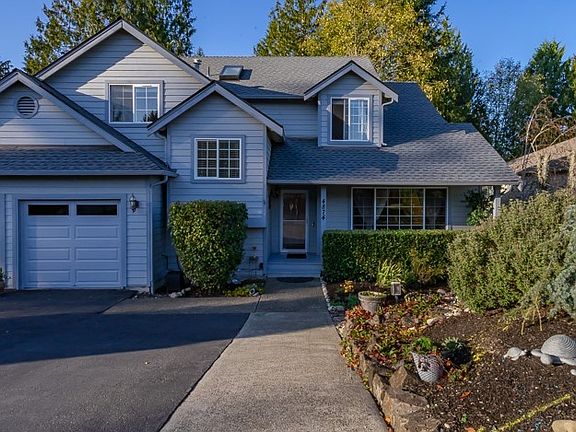 Mature landscaping and 2 car attached garage with brand new garage doors.