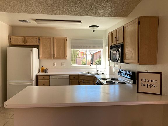 Kitchen includes fridge, dishwasher, microwave, and stove