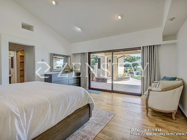 pacious primary bedroom with king bed and serene ambiance