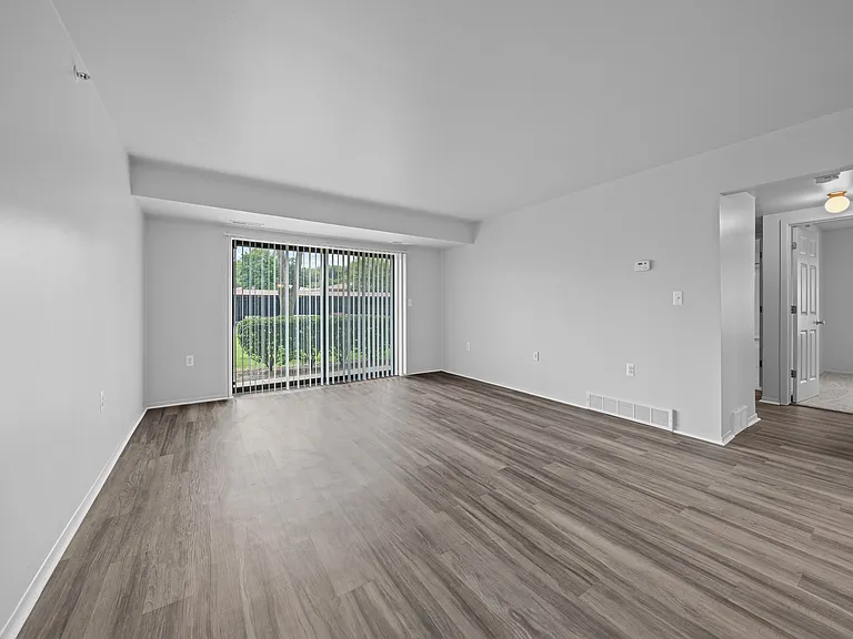Spacious living room with natural light at Westwood Village Apartments in Westland, MI