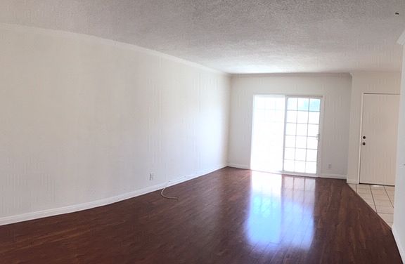 spacious living room with sliding patio door