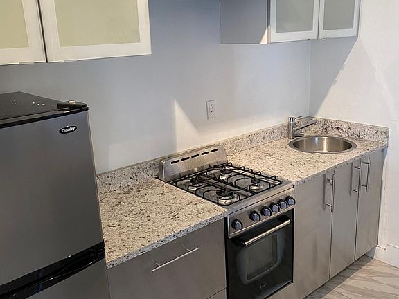 Kitchen with new stove. Newly remodeled cabinets.
