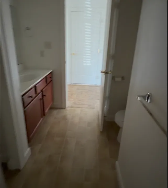 Full standard tub to left, toilet shown partially, closet to left, sink as shown. Lights are off in this picture