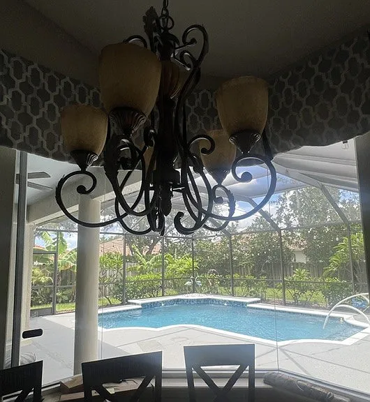 View of the pool and lanai from the kitchen sink.