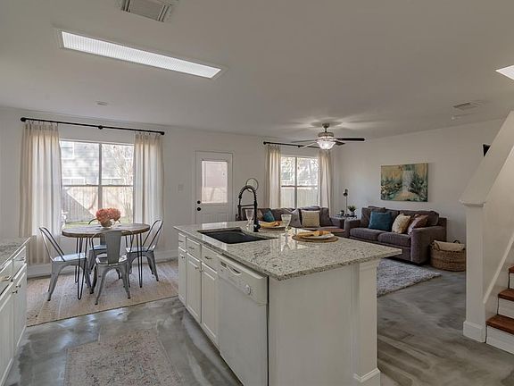 This gorgeous downstairs features granite countertops, concrete floors and freshly painted walls.