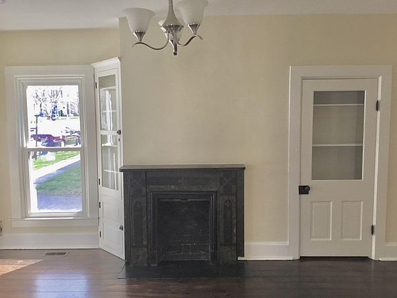 Front Room - Built in storage, non-operational fireplace with marble mantle