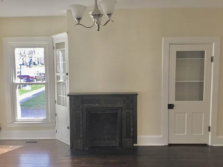 Front Room - Built in storage, non-operational fireplace with marble mantle