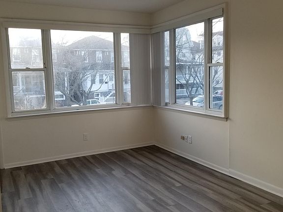 Living room/kitchen area, high ceilings, new flooring throughout