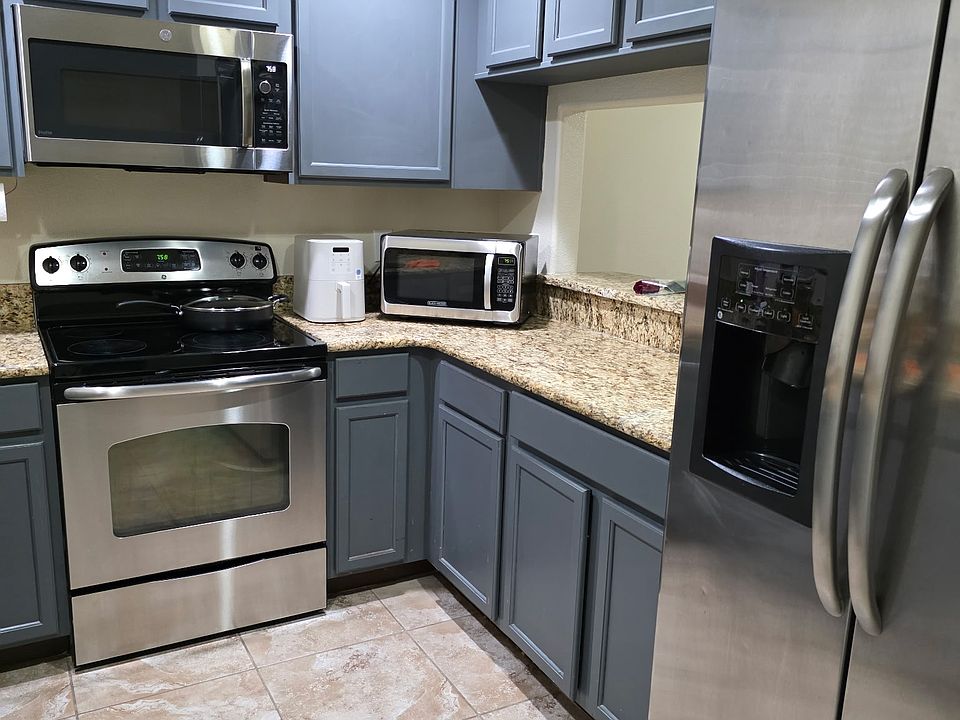 Kitchen with stainless steel appliances and pantry