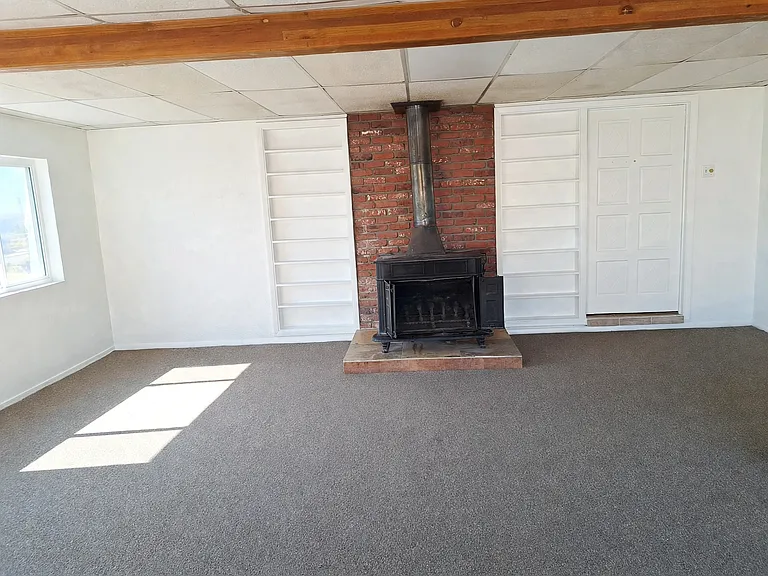 Huge sunroom with wood-stove and built in bookcases