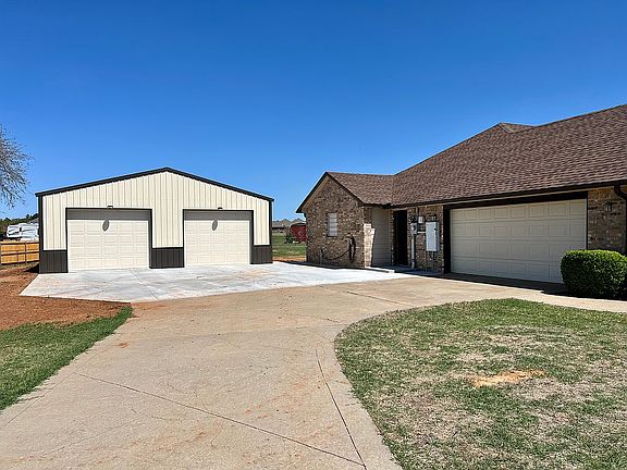 Driveway view with detached 